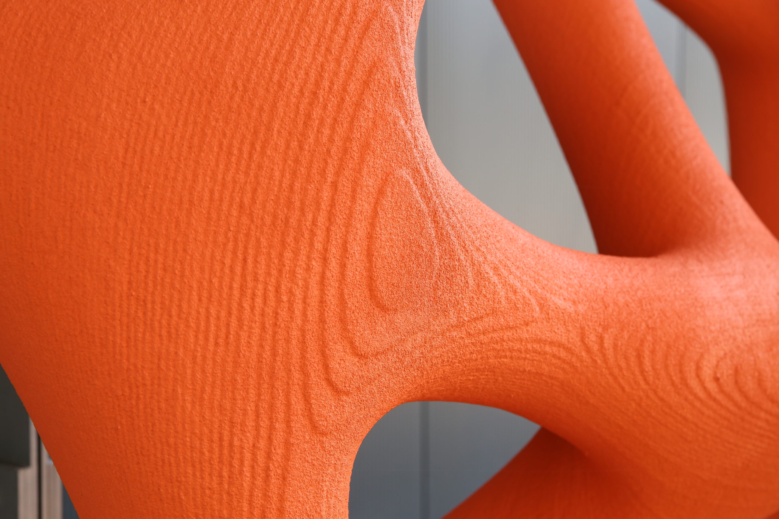 detail of orange painted piece for 3d printed facade
