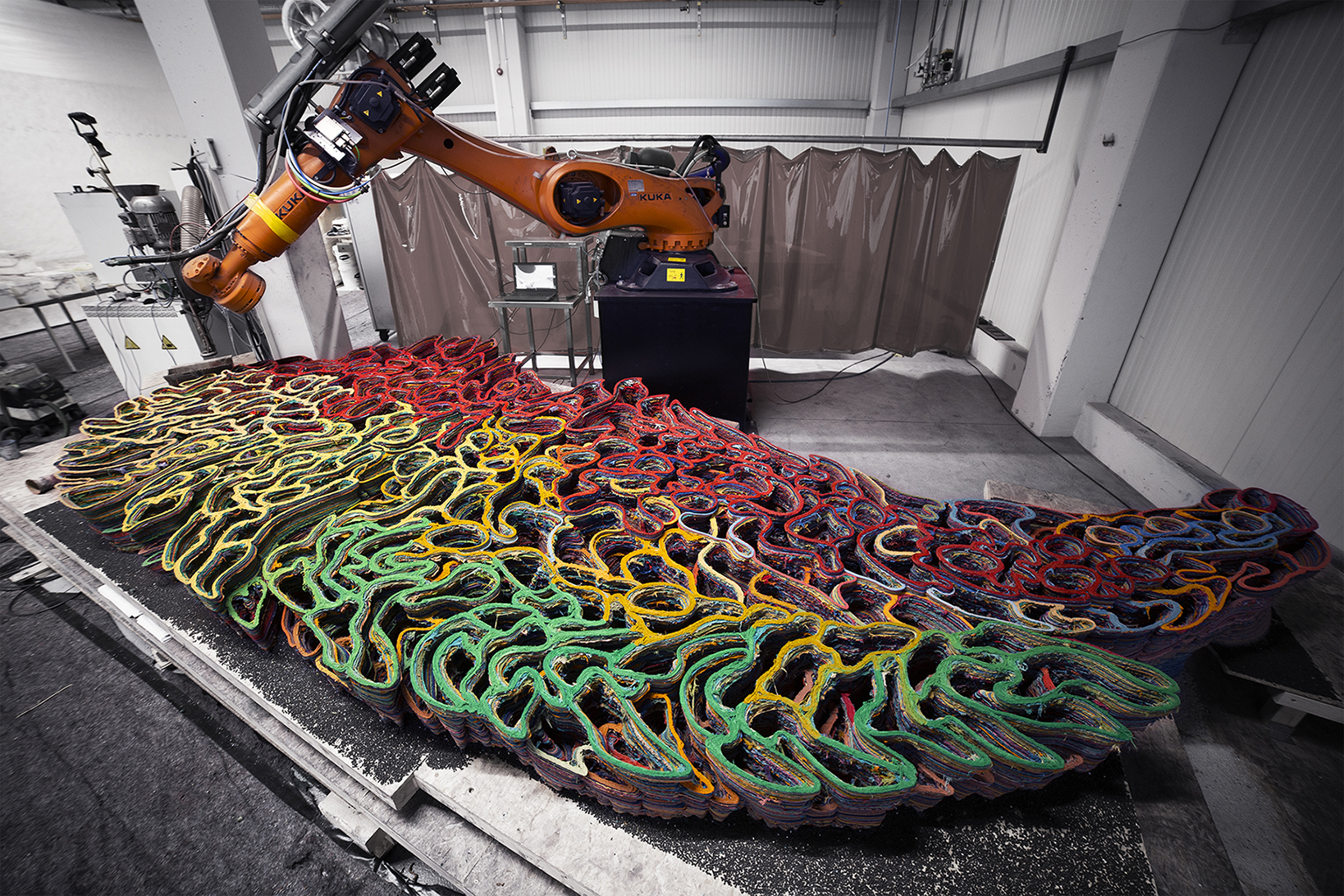robot in factory during 3d printing of large sculpture with different colour