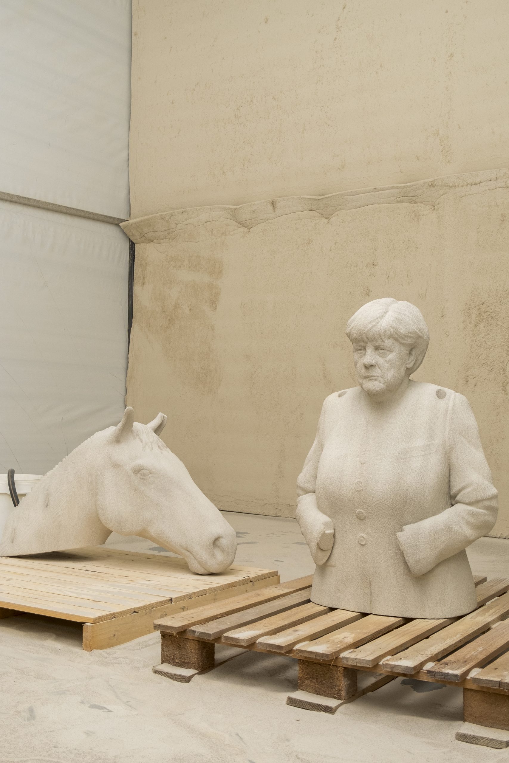 parts of 3d printed equestrian angela merkel during fabrication process